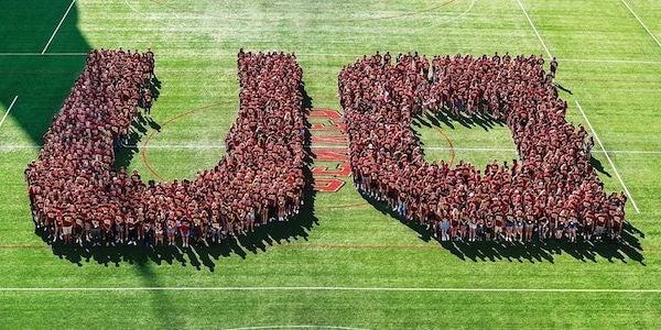 students in DU formation on soccer field